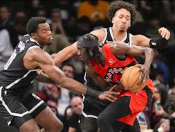 Brooklyn Nets centre Day'Ron Sharpe, left, and forward Jalen Wilson, background, guard Toronto Raptors forward Mouhamadou Gueye during the first half of an NBA basketball game Wednesday, April 10, 2024, in New York.