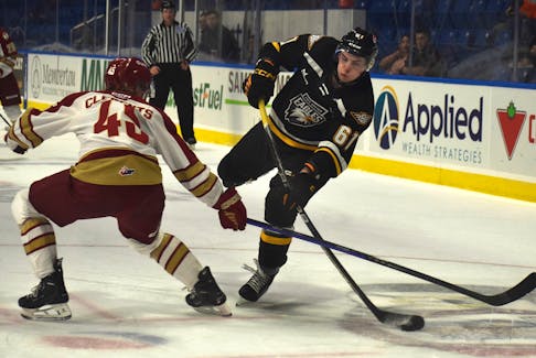Cam MacDonald of the Cape Breton Eagles, right, attempts a shot on goal during Quebec Maritimes Junior Hockey League action at Centre 200 in Sydney earlier this season. MacDonald says he wants to be more consistent when it comes to his offensive production the rest of the season. JEREMY FRASER/CAPE BRETON POST