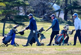 A trio of golfers walk to their next shot at the River Hills Golf and Country Club in Clyde River. Kathy Johnson