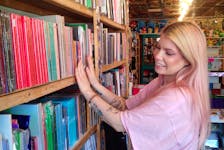 Natasha Wright arranges albums on the shelves in the store.