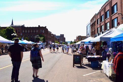 People browse the Downtown Farmers’ Market July 3. The downtown market will run on Sundays from 10 a.m. – 3 p.m. until September. - Alison Jenkins • The Guardian