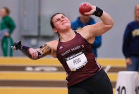 Katie Pegg, who was born without a radial bone in her right forearm, throws shot put for Saint Mary's at the Atlantic university track and field championships in Moncton in February. Pegg returned to the sport this year for the first time since the COVID-19 pandemic. - SMU ATHLETICS