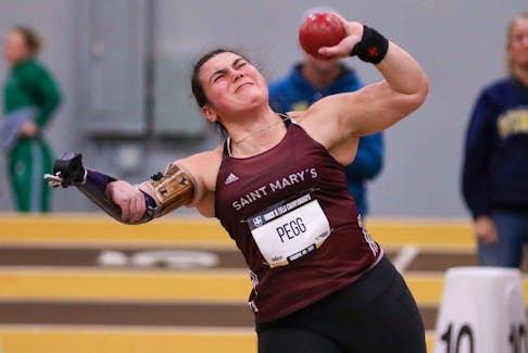 Katie Pegg, who was born without a radial bone in her right forearm, throws shot put for Saint Mary's at the Atlantic university track and field championships in Moncton in February. Pegg returned to the sport this year for the first time since the COVID-19 pandemic. - SMU ATHLETICS