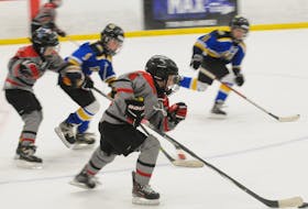 Nate Bartlett of the Bay Arena Rovers carries the puck down the ice as he is pursued by players on the Avalon Celtics in third-period action of their game in the 2024 Exile Under-9 invitational novice hockey tournament at the D.F. Barnes Arena on Saturday afternoon won 6-1 by the Rovers. -Photo by Joe Gibbons/The Telegram