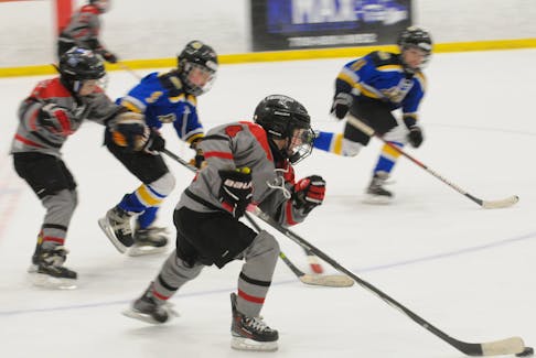 Nate Bartlett of the Bay Arena Rovers carries the puck down the ice as he is pursued by players on the Avalon Celtics in third-period action of their game in the 2024 Exile Under-9 invitational novice hockey tournament at the D.F. Barnes Arena on Saturday afternoon won 6-1 by the Rovers. -Photo by Joe Gibbons/The Telegram