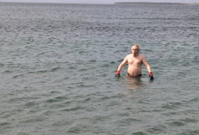 Taking the plunge in memory of his father Owen Glasco who passed away from Parkinsons’s Disease on August 24, 2018 at the age of 72, Robert Glasco of Pouch Cove, braved the chilly waters of Topsail Beach on Sunday afternoon, April 14, 2024, as a fundraiser for the Parkinson’s Society of Newfoundland. Glasco said he was ”hoping to raise a few hundred dollars for Parkinson’s in memory of dad, so I decided to do this dip in the water here today to honour him. I’ve done a few cold water events for various charities since 2017 and even shovelled snow in winter in shorts once,” added Glasco who said he hopes to make this an annual event. He was joined in the water by two supporters Krystle Hayden and Carolyn Staple, whose father John Staple has Parkinson’s disease. Friends for many years, Hayden said they do cold water exercise throughout the year and call themselves the “soul sisters.” Above, Glasco reacts to the cold water before he takes a quick seat in the cold waters. His mother Astrid Glasco watched form the parking lot.
-Photo by Joe Gibbons/The Telegram