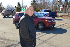 Dr. Peter Littlejohn of New Waterford watches traffic at the intersection of Union Highway and Lingan Road. BARB SWEET/CAPE BRETON POST