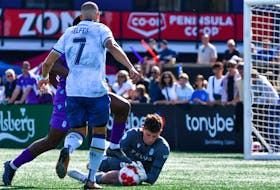 Pacific FC keeper Emil Gazdov makes a save in front of Halifax Wanderers forward Ryan Telfer during the Canadian Premier League season opener Saturday afternoon in Langford, B.C. Pacific won the match 1-0. - CANADIAN PREMIER LEAGUE