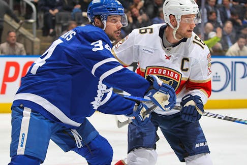 Aleksander Barkov of the Florida Panthers battles against Auston Matthews of the Toronto Maple Leafs.
