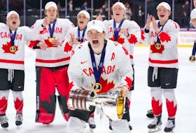 Stellarton's Blayre Turnbull celebrates with the championship trophy after Canada beat the United States 6-5 in overtime to win the IIHF world women's hockey championship on Sunday night in Utica, N.Y. - Hockey Canada