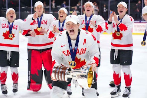 Stellarton's Blayre Turnbull celebrates with the championship trophy after Canada beat the United States 6-5 in overtime to win the IIHF world women's hockey championship on Sunday night in Utica, N.Y. - Hockey Canada