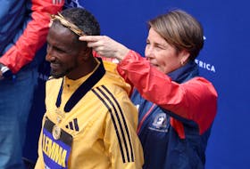 Athletics - The 128th Boston Marathon - Boston, Massachusetts, U.S. - April 15, 2024 Ethiopia's Sisay Lemma has a gold wreath placed on his head by Governor Maura Healey after winning the men's elite race