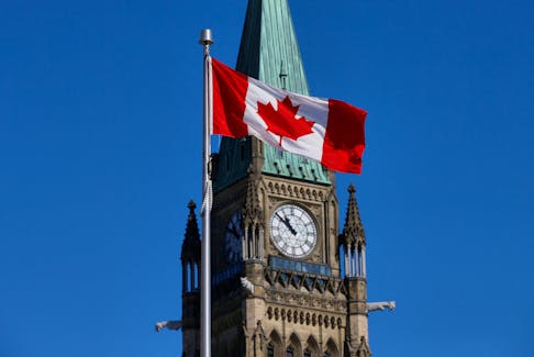 A Canadian flag flies in front of the Peace Tower on Parliament Hill in Ottawa, Ontario, Canada, March 22, 2017.