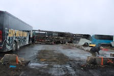 One of the old Cape Breton Eagles buses sits at Carabin’s & Transoverland Ltd., the site where a fire burned the business's main shop, a garbage truck, some scrap buses and the new Cape Breton Eagles bus nearly three weeks ago. Owner Craig Carabin said the shop will be rebuilt on the site, hoping to complete it before the summer. LUKE DYMENT/CAPE BRETON POST
