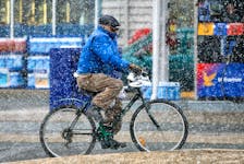MARCH 19, 2006-- Spring has not Sprung--A man bikes through Snow flurries and cold temperatures on Main St. in Dartmouth Sunday. Winter held on until the last day with highs reaching 3 degrees.