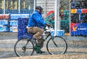 MARCH 19, 2006-- Spring has not Sprung--A man bikes through Snow flurries and cold temperatures on Main St. in Dartmouth Sunday. Winter held on until the last day with highs reaching 3 degrees.