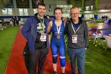 Keely MacGrath wears her bronze medal she won at the 2024 Canadian wrestling championships recently in Mississauga, Ont. With her, from left, are her father and coach, Matt MacGrath, and Tim Murphy, Wrestling P.E.I. builder and supporter. Contributed