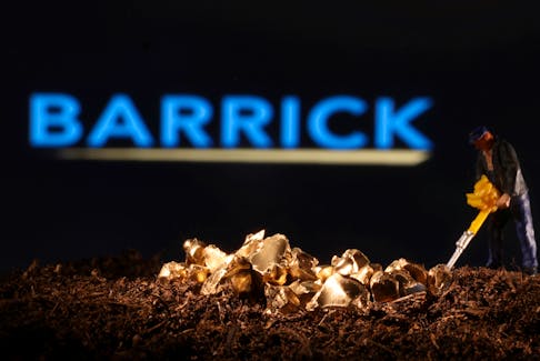 A small toy figure and gold imitation are seen in front of the Barrick logo in this illustration taken November 19, 2021.