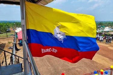 A Colombian flag marked with the acronym of the Revolutionary Armed Forces of Colombia (FARC) installed by the Central General Staff (EMC), a faction of the FARC that rejected the 2016 peace agreement and continued the armed struggle, flies at a school recently inaugurated by that armed group in the Llanos del Yari, Colombia April 12, 2024.