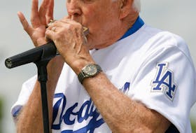 Brooklyn Dodgers legend Carl Erskine plays the harmonica prior to the Los Angeles Dodgers' final game at Dodgertown against the Houston Astros in Vero Beach, Florida March 17, 2008. The team said goodbye to their spring training home for the past 61 years with plans to move to Arizona next year.  