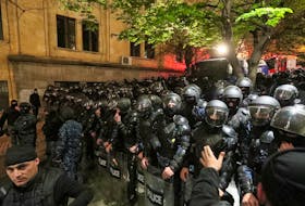 Law enforcement officers block a street during a protest against a draft bill on "foreign agents" in Tbilisi, Georgia April 15, 2024.
