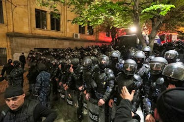 Law enforcement officers block a street during a protest against a draft bill on "foreign agents" in Tbilisi, Georgia April 15, 2024.