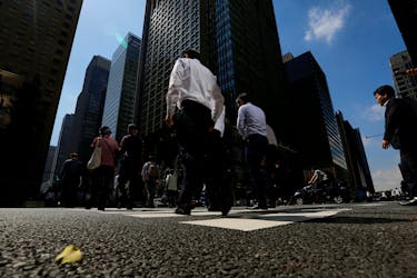 People walk on a crosswalk at a business district in central Tokyo, Japan September 29, 2017. Picture taken September 29, 2017.