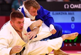 Tokyo 2020 Olympics - Judo - Men's 73kg - Last 32 - Nippon Budokan - Tokyo, Japan - July 26, 2021. Akil Gjakova of Kosovo in action against Nils Stump of Switzerland