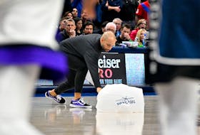 Nov 19, 2023; Dallas, Texas, USA; Sacramento Kings associate head coach Jordi Fernandez picks up a parachute giveaway item that fell onto the court during play during the second half of the game between the Dallas Mavericks and the Sacramento Kings at the American Airlines Center. Mandatory Credit: Jerome Miron-USA TODAY Sports