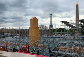 A view shows the Eiffel Tower and the Luxor Obelisk as people work on the Olympic and Paralympic construction site of The Urban Park venue at the Place de la Concorde ahead of the Paris 2024 Olympic Games in Paris, France, March 27, 2024.