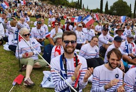 Paris 2024 Olympics - Olympic Flame Lighting Ceremony - Ancient Olympia, Greece - April 16, 2024 Spectators dressed in the colours of the flag of France applaud during the Olympic Flame lighting ceremony for the Paris 2024 Olympics