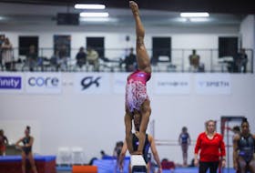 Simone Biles runs through a portion of her beam routine during the second day of a two-day media event with the USA Gymnastics team ahead of the 2024 Olympics in Katy, Texas, U.S. February 5, 2024. 