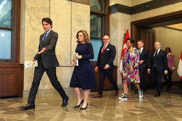 Canada's Prime Minister Justin Trudeau and Finance Minister Chrystia Freeland arrive to pose for a picture holding the 2024-25 budget, on Parliament Hill in Ottawa, Ontario, Canada, April 16, 2024. 