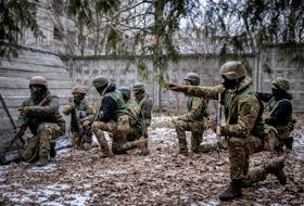 Volunteers who aspire to join the 3rd Separate Assault Brigade of the Ukrainian Armed Forces listen to an instructor during basic training, amid Russia's attack on Ukraine, at an undisclosed location in the Kyiv region, Ukraine January 9, 2024.