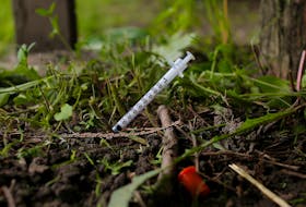 A used needle sits on the ground in a park in Lawrence, Massachusetts, U.S., May 30, 2017, where individuals were arrested earlier in the day during raids to break up heroin and fentanyl drug rings in the region, according to law enforcement officials.  