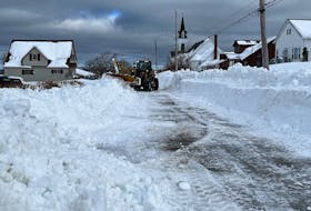 A snow machine struggles to push snow on Thompson Street in New Waterford Feb. 7. BARB SWEET/CAPE BRETON POST