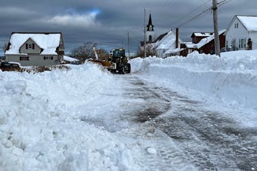 A snow machine struggles to push snow on Thompson Street in New Waterford Feb. 7. BARB SWEET/CAPE BRETON POST