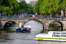 Tourists boats pass on a canal in Amsterdam, Netherlands, May 16, 2018. Picture taken May 16, 2018. 