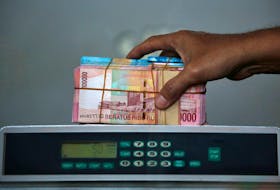 Indonesian rupiah banknotes are seen after they were counted at a money changer in Jakarta, Indonesia September 4, 2018.