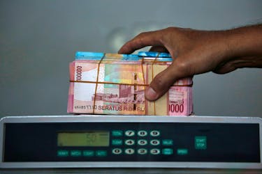 Indonesian rupiah banknotes are seen after they were counted at a money changer in Jakarta, Indonesia September 4, 2018.