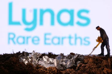 A small toy figure and mineral imitation are seen in front of the Lynas Rare Earths logo in this illustration taken November 19, 2021.