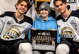 Charlottetown Islanders defenceman Marcus Kearsey, left, and forward and team captain Michael Horth, right, chat with Marlie Orlowski, who joined the Islanders as an honourary assistant coach for a home game against Moncton in March. Orlowski dropped the puck for the ceremonial faceoff with the Make A Wish Canada’s P.E.I. branch before the game but was not aware what would happen next. After the draw, Kearsey presented Orlowski with Roary, a cuddly-stuffed lion, to signify her wish will be coming true. Charlottetown Islanders Photo • Special to The Guardian