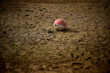 A buoy is seen on the banks of the partially dry Lake Montbel at the foot of the Pyrenees Mountains as France faces records winter dry spell raising fears of another summer of droughts and water restrictions, March 13, 2023.