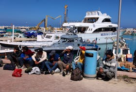 Migrants wait at a fishing shelter in Paralimni, Cyprus, April 5, 2024. This week the island has seen un unprecedented influx of hundreds of refugees from Syria, whom Cypriot authorities said set off from the coast of Lebanon.