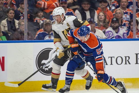 Dylan Holloway (55) of the Edmonton Oilers gets position on Jack Eichel (9) of the Las Vegas Golden Knights at Rogers Place in Edmonton on April 10, 2024.