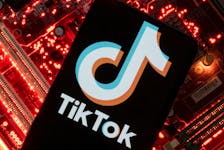 A smartphone with a displayed TikTok logo is placed on a computer motherboard in this illustration taken February 23, 2023.