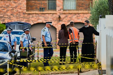 Police enter the Assyrian Christ The Good Shepherd Church with a clergyman after a knife attack took place during a service on Monday night, in Wakely, in Sydney, Australia, April 17, 2024.