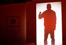Japan's volleyball player Yuji Nishida is silhouetted at an unveiling ceremony of official uniforms for the Paris Olympics and Paralympics in Tokyo, Japan April 17, 2024.