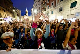 Demonstrators raise their hands to symbolise the uterus, at a protest organized by Non Una di Meno (Not One Less) movement and feminist collectives, to mark International Safe Abortion Day, in Rome, Italy September 28, 2022.