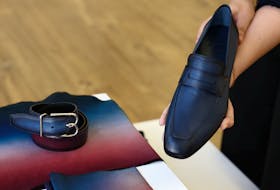 An employee shows a moccasin shoe that will be worn by the French team athletes for the opening ceremony by LVMH's upscale menswear label Berluti, in a showroom at Berluti headquarters in Paris, France, April 10, 2024.